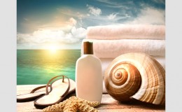 Sunblock lotion and towels and ocean scene